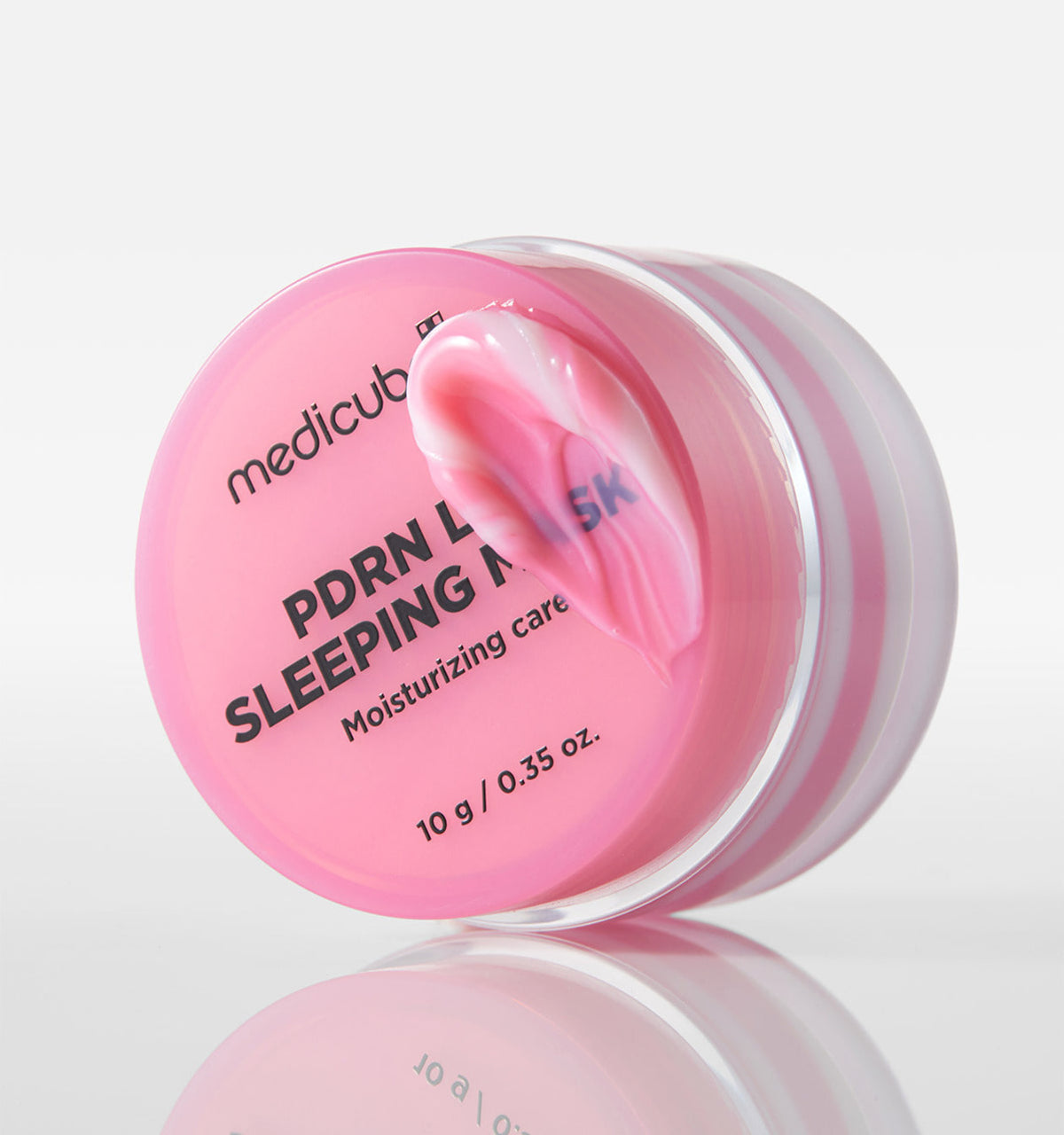 Medicube PDRN Lip Sleeping Mask jar showing the 10g lid label and a pink balm smear.