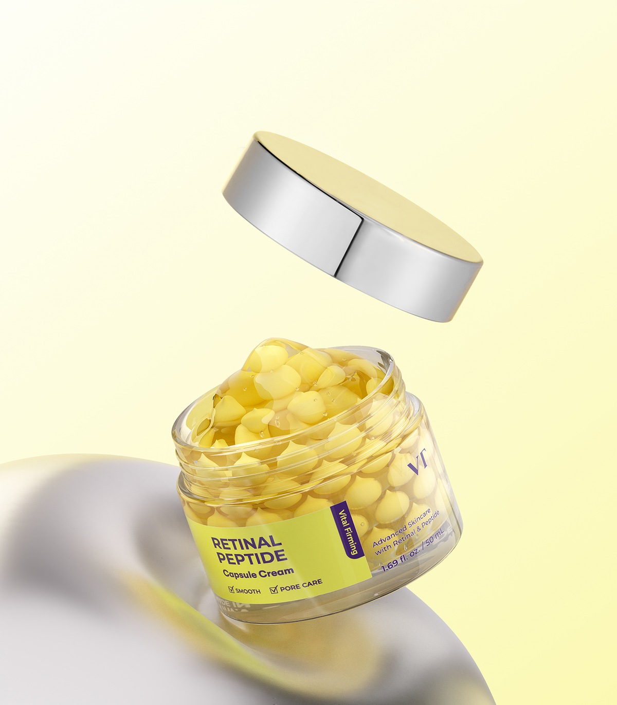 VT Retinal Peptide Capsule Cream 50ml with its silver lid removed, showing yellow capsules inside the clear jar