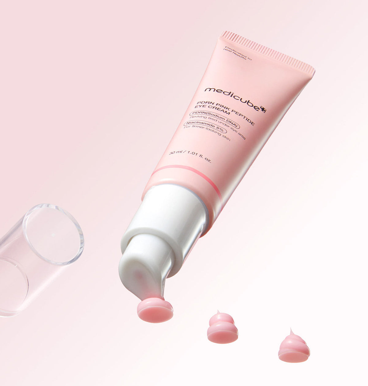 Medicube PDRN Pink Peptide Eye Cream 30ml with the cap removed and pink cream at the pump