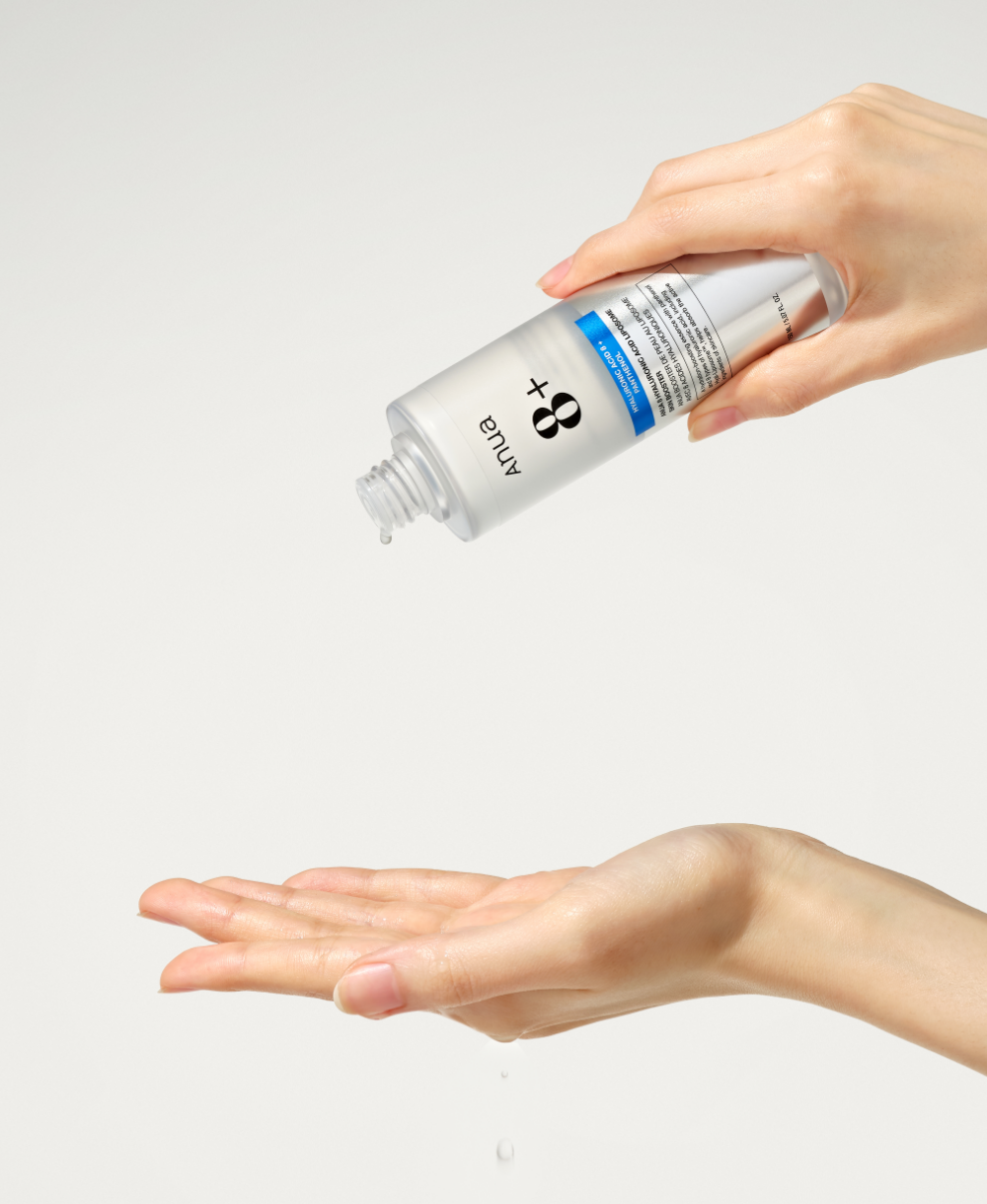 ANUA 8 Hyaluronic Acid Liposome Skin Booster 150ml being poured from the bottle into a palm