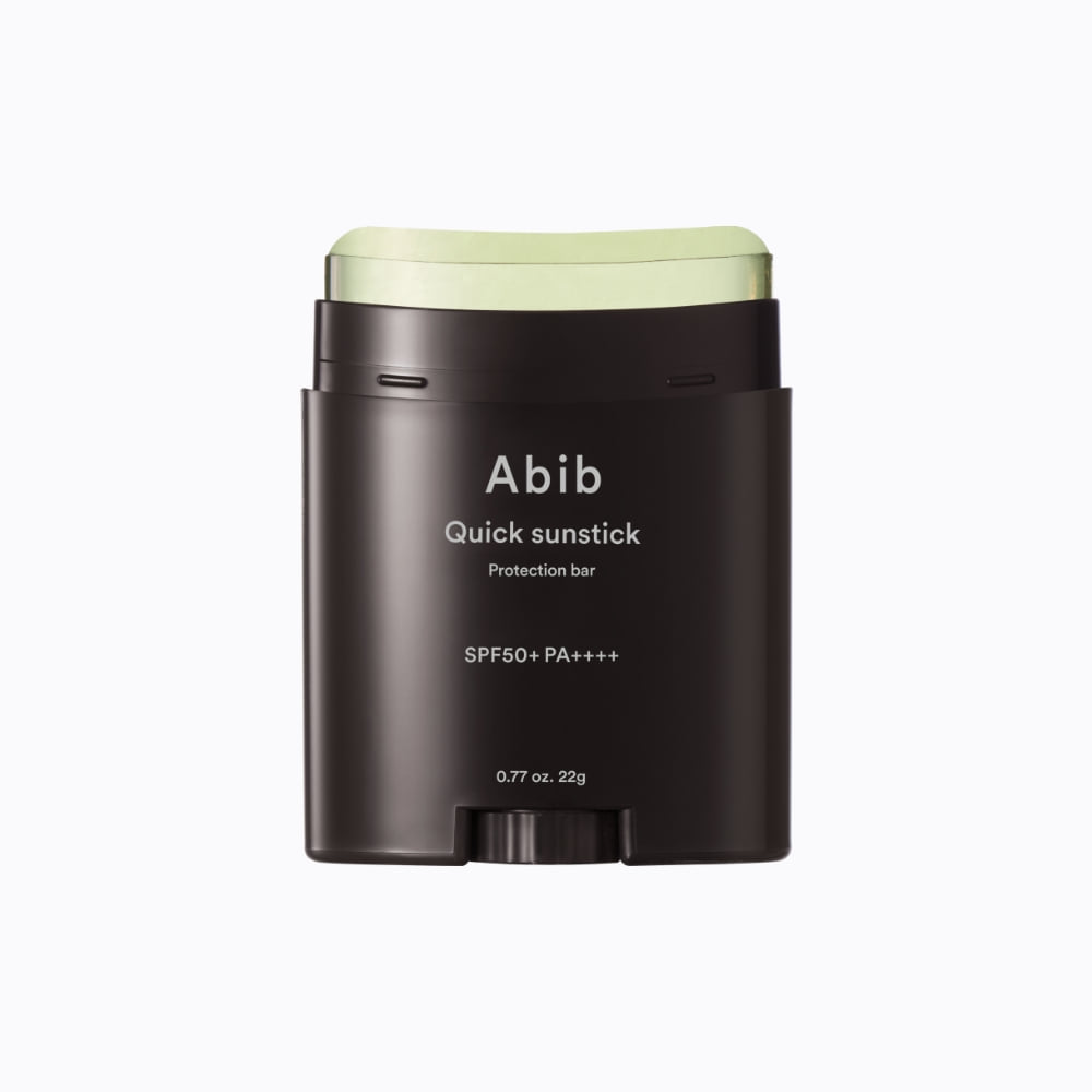 Abib Quick Sunstick Protection Bar 22g with cap removed, showing the curved pale-green stick