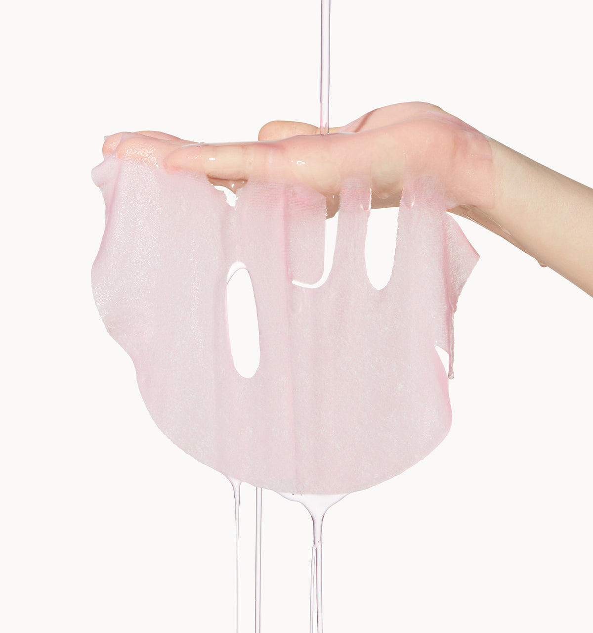 Unfolded Medicube PDRN Pink Vita Coating Mask held in a hand, showing the pink sheet and face openings.