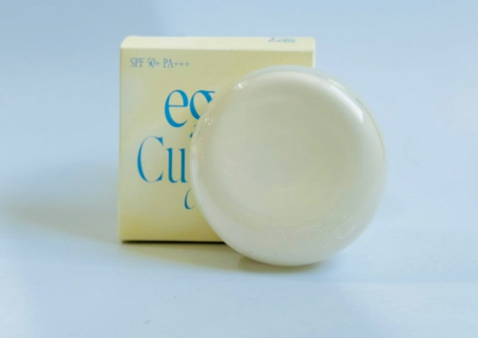 Closed pale-yellow FWEE Cushion Egg Fit Cover compact beside its box