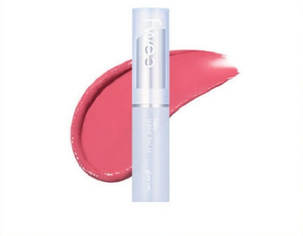Closed pale-blue FWEE Shine Balm Glass tube beside a pink color swatch
