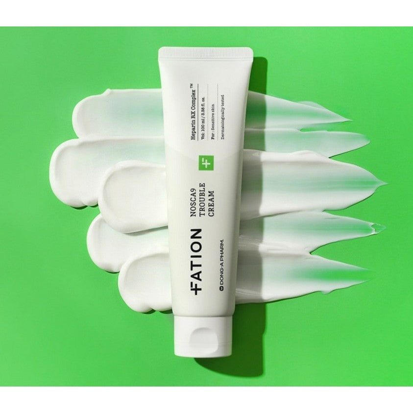White FATION NOSCA9 Trouble Cream tube over white cream swatches on a bright green background