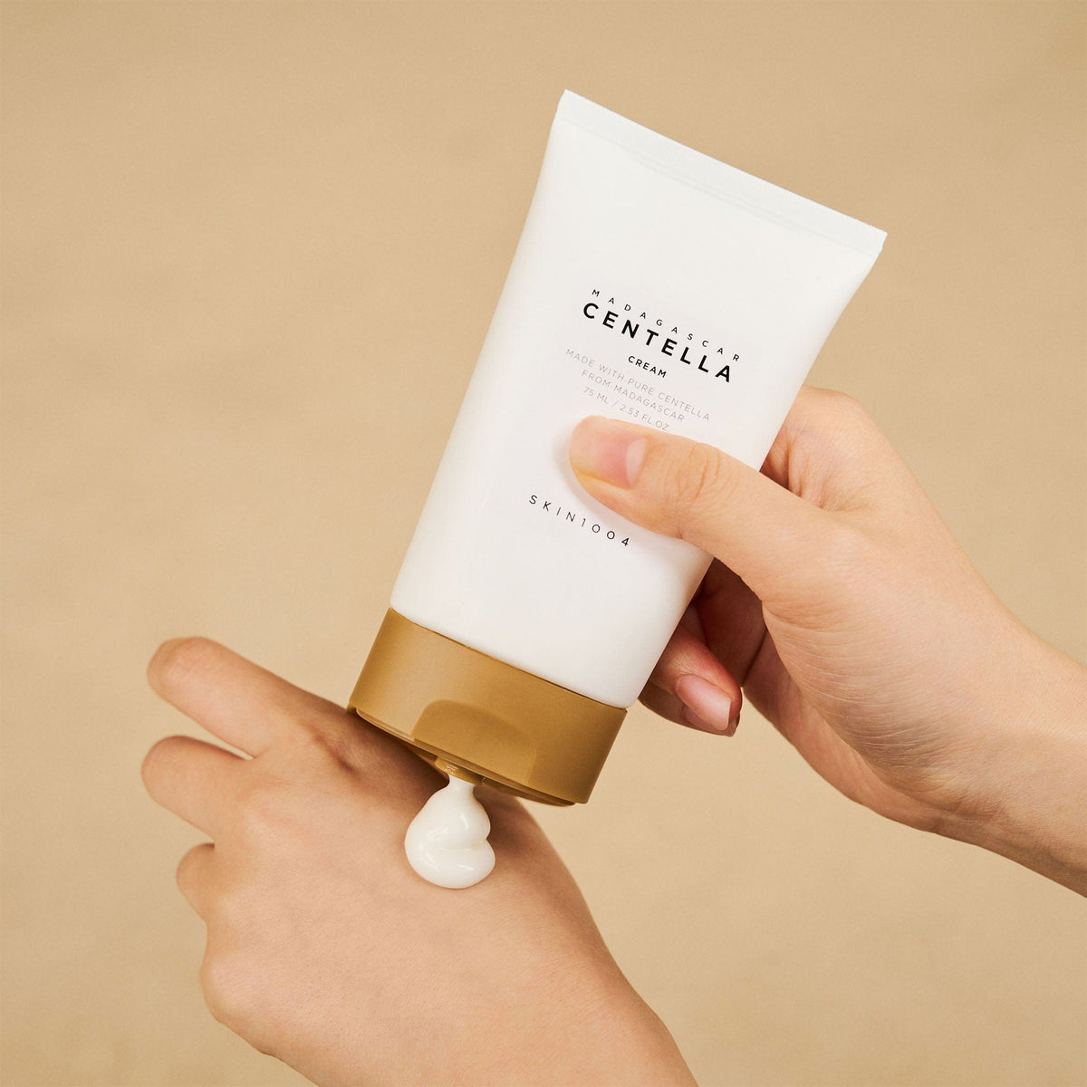 SKIN1004 Madagascar Centella Cream 75ml being dispensed onto the back of a hand